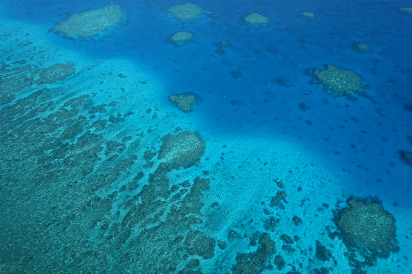 Aerial view of reef patterns and deep blue waters on the Great Barrier Reef